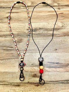 Georgia Bulldog lanyards, 17" long with breakaway clasp and black swivel hooks.  Beech wood 8mm beads with red, black, white spacers. Nylon black string with red and black hexagon silicone beads. Black Lanyard With Lobster Clasp As Gift, Black Beaded Adjustable Lanyards, Adjustable Black Lanyards For Everyday Use, Georgia Bulldog, Black Lanyard, 8mm Beads, Georgia Bulldogs, Silicone Beads, Badge Holders Lanyard