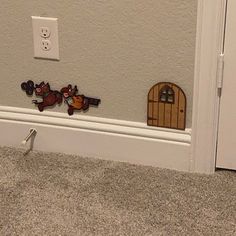 there is a door and some cartoon figures on the wall next to the door way