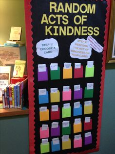 a bulletin board with random acts of kindness written on it in front of bookshelves