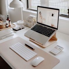 an open laptop computer sitting on top of a desk next to a mouse and keyboard