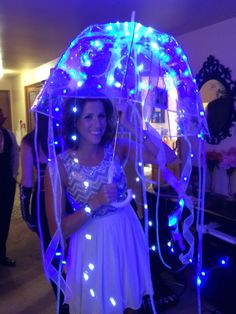 a woman holding an umbrella with blue lights on it