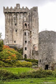 an old castle is shown in the middle of a field