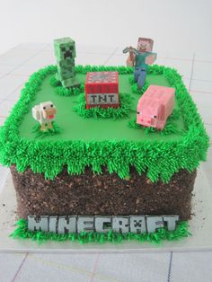 a cake that is made to look like a minecraft field with farm animals on it