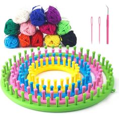 colorful yarn and crochet hooks laid out on a white surface with knitting needles in the background