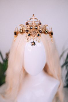 a white mannequin head wearing a gold tiara