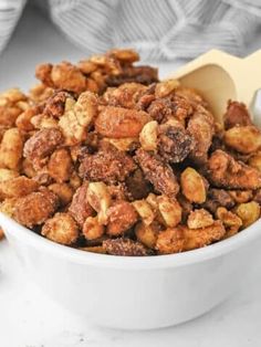 a white bowl filled with nuts on top of a table