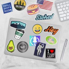 an assortment of stickers and decals on a computer keyboard, including a keyboard mouse