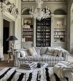 a living room filled with furniture and a chandelier