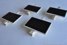 four black and white square objects sitting on a table