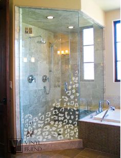 a bathroom with a walk in shower next to a bath tub