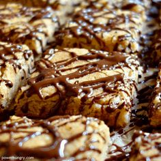 chocolate drizzled on top of some cookies