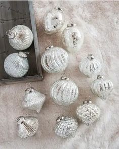 twelve silver glass ornaments on a white furnishing