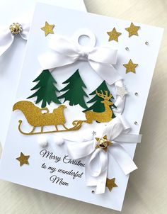 a christmas card with gold and white decorations