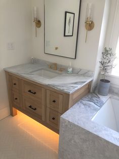 a bathroom with two sinks and a large mirror on the wall next to a bathtub