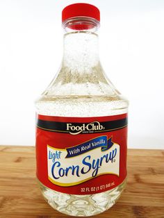 a bottle of corn syrup sitting on top of a wooden table