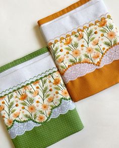 two pieces of fabric with flowers and lace on them sitting next to each other in front of a white background