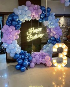 balloons are arranged in the shape of a circle and number 3 on display at a birthday party