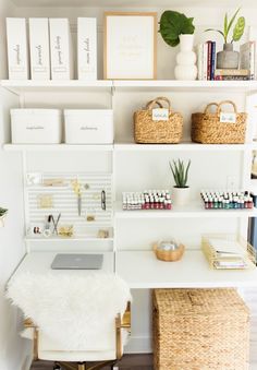 a white desk topped with lots of shelves filled with books and office supplies on top of it