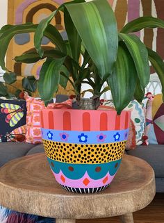 a potted plant sitting on top of a wooden table