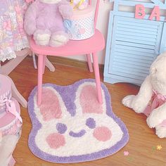 two stuffed animals sitting on top of a pink chair next to a baby crib