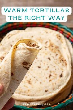 a person holding a tortilla in their hand with the text warm tortillas the right way