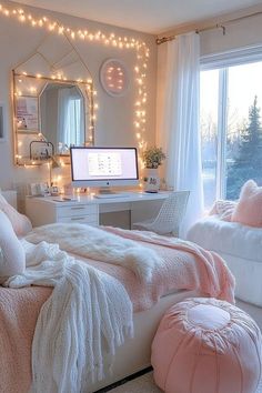 a bedroom decorated in pink and white with lights on the wall, bed, desk and chair