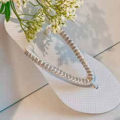 Rhinestones Bridal Flip Flops, custom crystal bridal sandals, Rhinestone shoes for beach destination wedding - custom color your choice Cute wedding flip flops, made with flat white flip flops, silver stone chain and silk thread for extra softness. The thread can change according to the colors of your wedding, let me know how you want them and I will design them for you on that special day Also available with golden rhinestones Beautiful sandals for beach / summer weddings and for a bridal party Elegant Silver Beach Flip Flops, Bedazzled Silver Sandals For The Beach, Silver Bedazzled Sandals For Beach, Silver Bedazzled Sandals For The Beach, Silver Bling Wedding Sandals, White Rhinestone Sandals For Vacation, White Sandals With Rhinestones And Adjustable Fit, Adjustable Bling Beach Sandals, Adjustable Bling Sandals For Beach