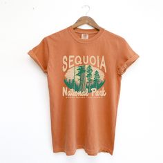 Step into the wild with our Yam-colored Sequoia National Park Comfort Colors T-shirt. This vibrant tee captures the rich, earthy tones of Sequoia National Park’s famed landscapes, mirroring the deep hues of the park’s majestic sequoia trees at sunset. Made from 100% ring-spun cotton, this garment-dyed shirt is as durable as it is comfortable, designed to withstand the rigors of outdoor adventures while maintaining a soft feel. The warm yam color evokes the adventurous spirit and awe-inspiring be Fall Graphic Print T-shirt For Outdoor Activities, Graphic Print T-shirt For Outdoor Activities In Fall, Casual Brown Tops For Outdoor Activities, Fall Adventure Graphic Print Top, Graphic Tee For Adventure, Fall Adventure Top With Graphic Print, Graphic Print Top For Adventure In Fall, Fall Adventure T-shirt With Letter Print, Summer Adventure Graphic Print T-shirt