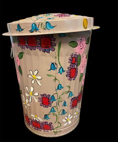 a colorful flowered vase is shown against a black background