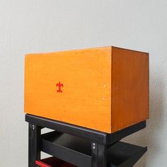 a wooden box sitting on top of a shelf