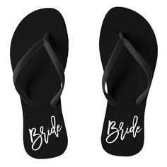 a pair of black flip flops with the monogrammed initials