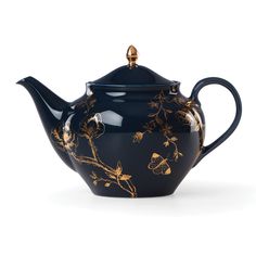 a blue tea pot with gold flowers on it