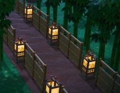 several lanterns lit up in the middle of a path