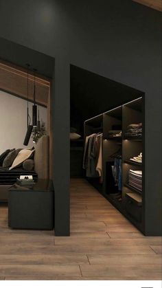 an open closet with clothes hanging in it