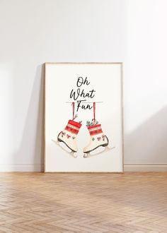 a white framed poster with red and black stockings hanging from it's sides on a wooden floor