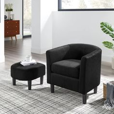 a living room with a chair and ottoman next to a plant in a vase on the floor