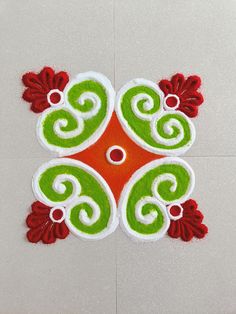 an intricately designed design on the floor in red, green and white color scheme