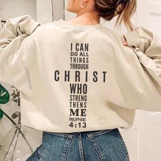 Philippians 4:13 Sweatshirt - Bible Verse Sweater I can do all things through Christ who strengthens me. Christian Sweater Features: ✨50% cotton, 50% polyester  ✨ Available in a range of sizes and colors, it's suitable for both men and women. 🎁 Christian Gift: Looking for a thoughtful gift for a fellow believer or someone special? This Scripture sweatshirt makes a meaningful present for birthdays, Christmas, baptism gift, gift for her, gift for fellow church goer or any special occasion. Share Christian Sweaters, Jesus Clothes, Cross Shirt, Jesus Sweatshirts, Faith Clothing, Cross Shirts, Christian Sweatshirt, Fashion Days, Christian Clothing