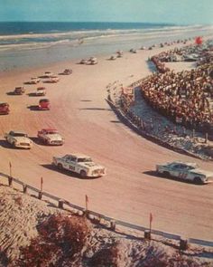 an old photo of cars racing on the beach