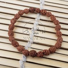 📿Our Three Mukhi Bracelet is handcrafted with Natural Three 3 Mukhi Rudraksha Beads. 3 Mukhi Rudraksha is the form of all three powers, Satva, Raja and Tantra and represents the three trinities (Tridev), lord Shiva, Lord Vishnu and Lord Brahma. This Rudraksha denotes desires, knowledge and actions. It is a very auspicious Mala that ensures good health and a guilt-free existence to the wearer. It is the seed of vitality. All the means required for fulfilling tasks are given to the wearer.  The T Traditional Hand Wrapped Brown Bracelet, Traditional Handmade Brown Bangle, Handmade Bracelets For Puja And Festivals, Spiritual Bangle Bracelets For Festivals, Traditional Handmade Rosary Bracelet With Round Beads, Traditional Handmade Rosary Bracelet, Traditional Handmade Brown Stretch Bracelet, Spiritual Beaded Bangle Bracelets For Festivals, Beaded Bracelets For Meditation And Festivals