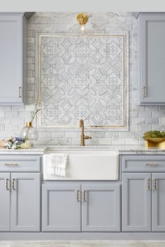 the front cover of modern mosaics magazine, featuring gray cabinets and white countertops