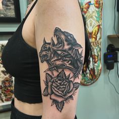 a woman with a wolf and rose tattoo on her arm