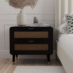 a black and gold chest of drawers next to a white bed