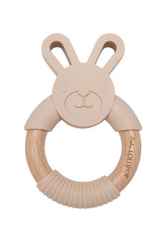 a wooden ring with a bunny face on it's front and back ends, in beige