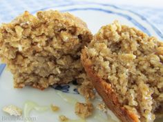 an oatmeal muffin is cut in half on a blue and white plate