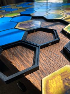 a close up of several different colored hexagons on a wooden table top