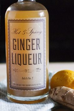 a bottle of ginger liquor next to an orange