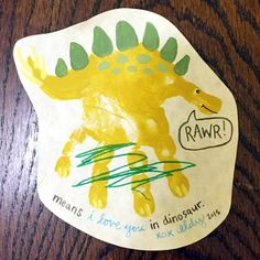 a child's drawing of a dinosaur on a paper plate