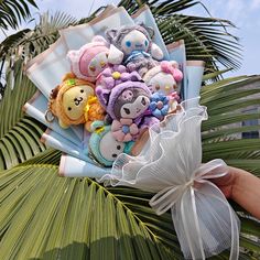 a bunch of stuffed animals sitting on top of a palm tree