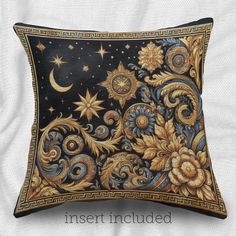 an intricately decorated pillow with stars and flowers on the front, sitting on a white sheet